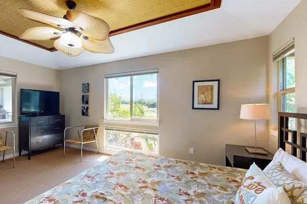 Master bedroom with king room, a flat screen tv and an en-suite bathroom.