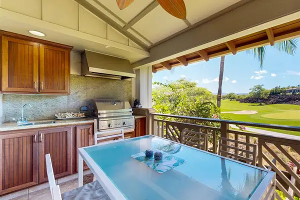 Private lanai and outdoor kitchen with dining for six.