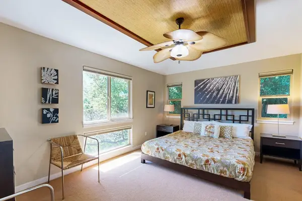Master bedroom with king room, a flat screen tv and an en-suite bathroom.