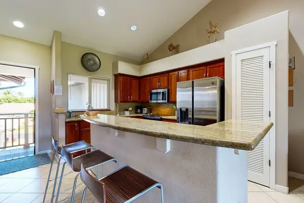 Newly remodeled kitchen with large island and bar stools for extra seating.