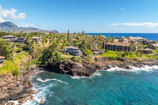 View of the coastline as the waves crash into the cliffs below the home.