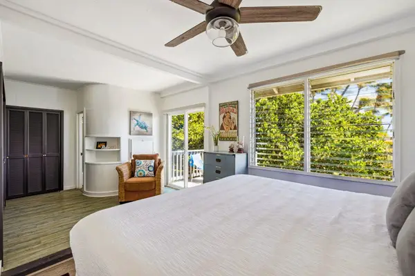 Guest room with king bed, private lanai access and a great area to sit and read a book in the afternoon.
