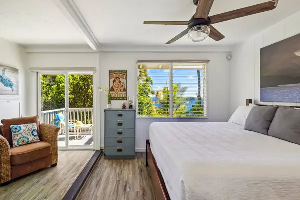 Guest room with king bed, private lanai access and a great area to sit and read a book in the afternoon.