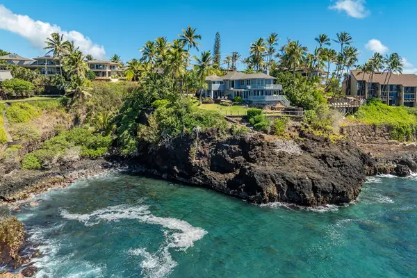 View of the coastline as the waves crash into the cliffs below the home.