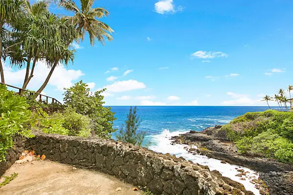 View of the coastline as the waves crash into the cliffs below the home.