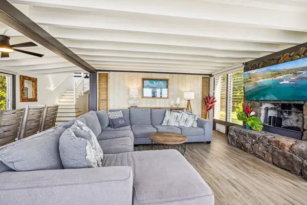 Large living room with sofa bed, flat screen tv and lots of natural light.