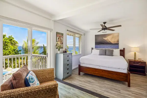 Guest room with king bed, private lanai access and a great area to sit and read a book in the afternoon.