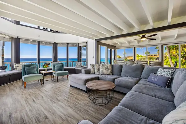 Large living room with sofa bed, flat screen tv and lots of natural light.