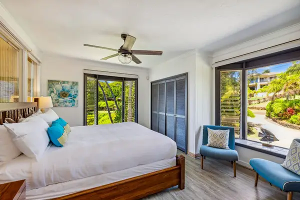 Master bedroom with a king bed, huge picture windows and access to your private lanai.