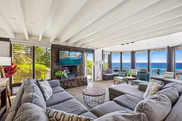 Spacious living room with panoramic views thanks to all of the glorious windows.
