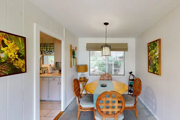 Natural light fills the dining area with warmth and inviting island charm