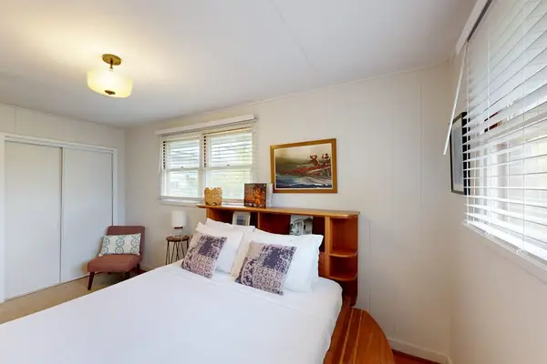 Cozy queen bed creates the perfect retreat inside the welcoming master bedroom