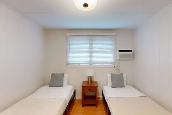 Relax in the second bedroom featuring two twin beds and welcoming comfort