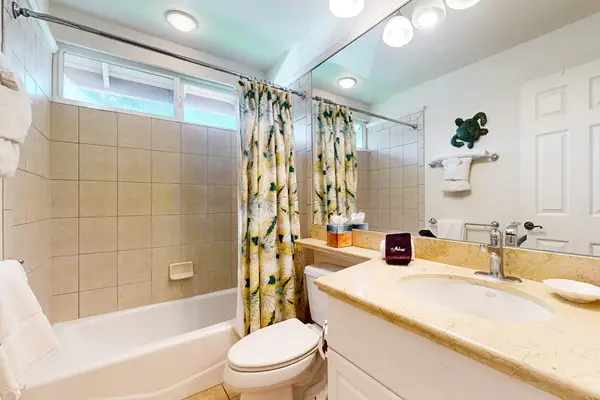 Crisp Guest Bathroom Featuring Tub And Shower Combo