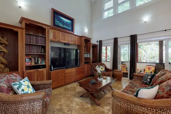 Large open-concept living room with a flat screen tv open to the upstairs.