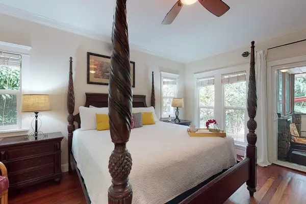 Master bedroom with king bed, flat screen tv, lanai access and an en-suite bathroom.