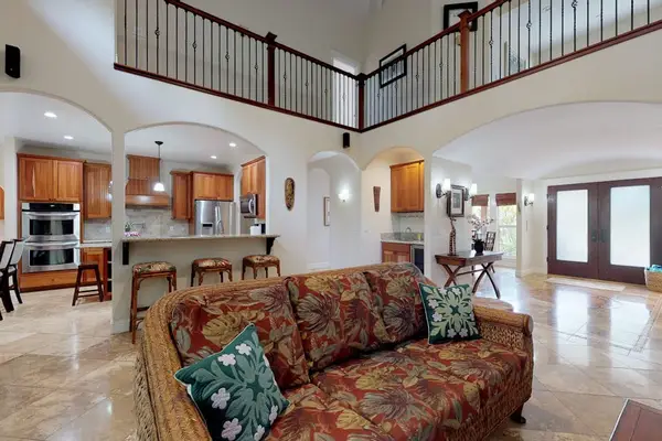 Living room open to the kitchen and the upstairs loft for the open air feel.