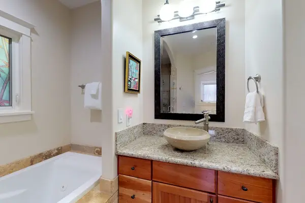Guest bathroom with garden tub and walk-in shower.