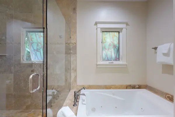 Master bathroom complete walk-in shower and Jacuzzi tub.