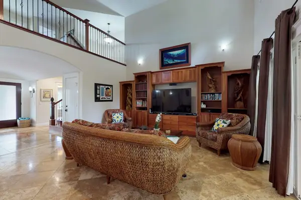 Large open-concept living room with a flat screen tv open to the upstairs.