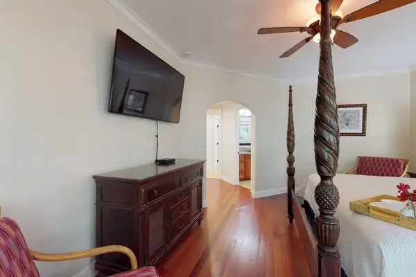 Master bedroom with king bed, flat screen tv, lanai access and an en-suite bathroom.