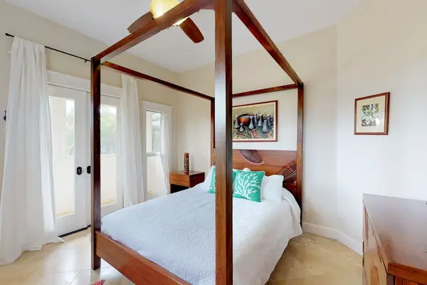 Guest room with queen bed and lanai access.