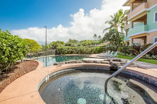Resort Hot Tub and Swimming Pool Deck with Handrail Entry and Tropical Surroundings