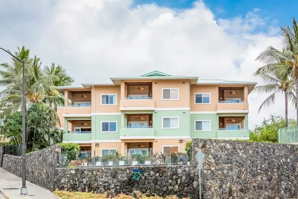​Three-Story Resort Building Exterior Elevated Above Decorative Stone Wall