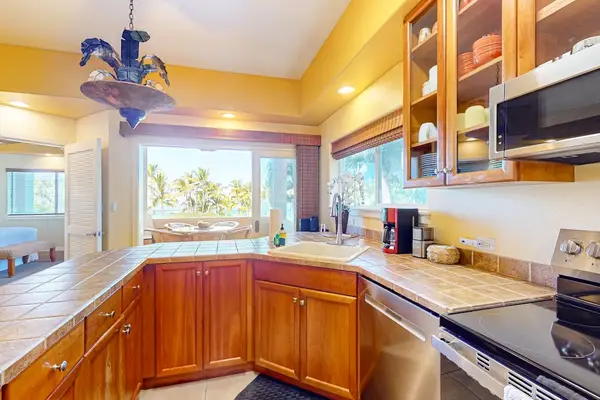 Bright Kitchen Corner with Ample Counter Space, Large Windows, and Modern Appliances