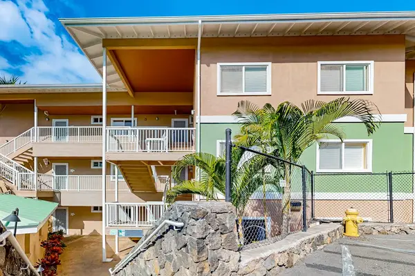 ​Multi-Level Resort Exterior Featuring Exterior Balconies, Covered Walkways, and Stone Retaining Wall