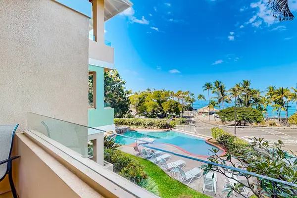 Private Balcony View Overlooking the Resort Pool, Lush Grounds, and Ocean Horizon
