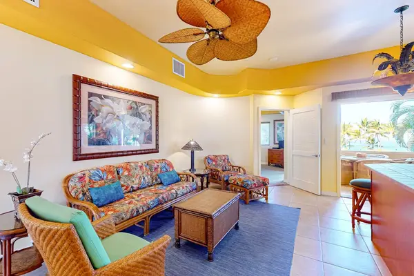 Open-Concept Living Room with Sofa Seating, Ceiling Fan, and Adjacent Dining Area