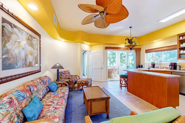 Open-Concept Living Area and Kitchen Island Bar with Patio Access