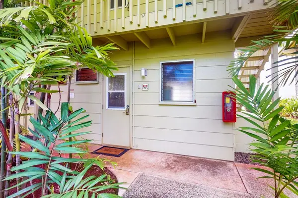 Well-maintained exterior surrounded by lush tropical landscaping.