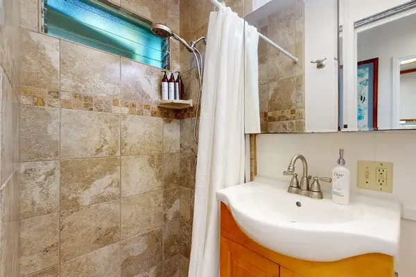 Contemporary bathroom with a tiled walk-in shower and vanity.