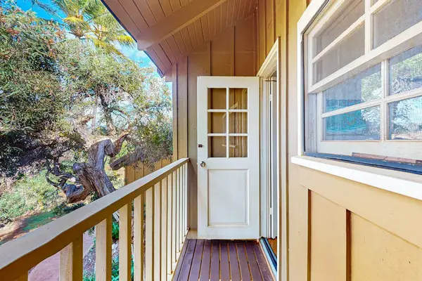 Covered balcony provides a welcoming entry with tropical outdoor views