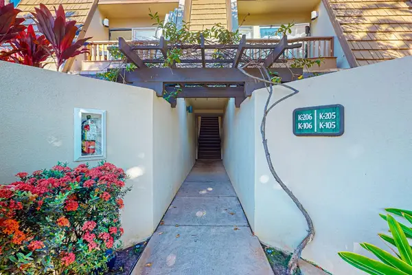 Welcoming property entrance framed by colorful blooms