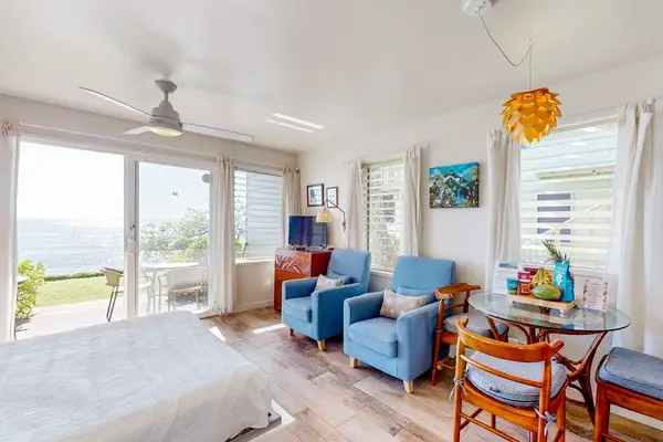 Bright studio featuring comfortable seating and beautiful ocean views.