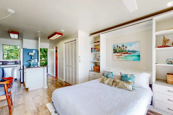 Bright studio featuring a comfortable sleeping area and open island-style layout.