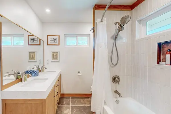 Second Bathroom features soaking tub vanity and bright glass shower enclosure