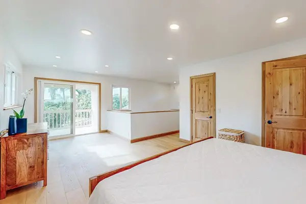 Opens toward garden views with dresser and wood doors