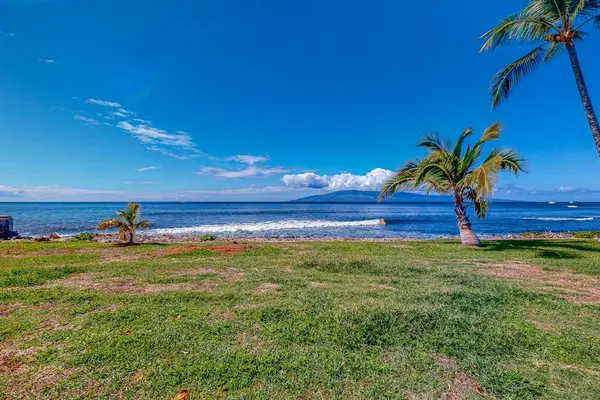 Enjoy peaceful ocean views across the resort's open green space.
