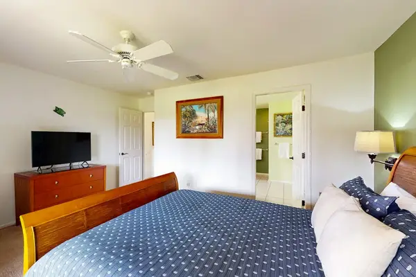 Master bedroom with king bed, flat screen tv and an en-suite bathroom.