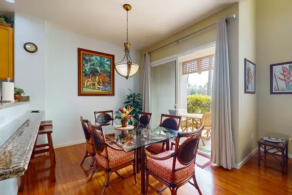 Dining room with seating for six and barstools at the connected kitchen counter for extra seating.