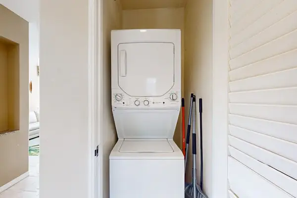 Washer and dryer area provides convenient garment care beside patio