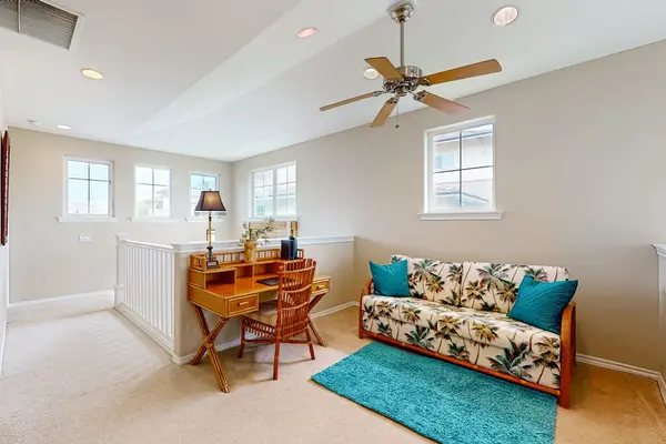 Living room includes colorful seating ceiling fan and resort views