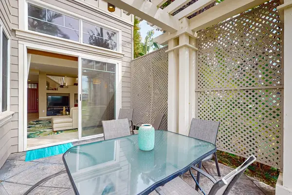 Covered patio offers outdoor dining with garden views and air