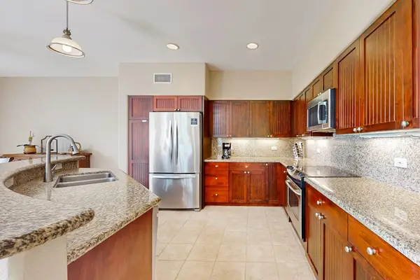 Kitchen and dining areas shaThird bedroom offers twin beds ceiling fan and comfortable storagere an open layout with appliances
