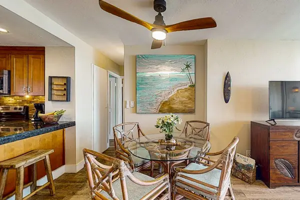 Dining room with seating for four and barstools at kitchen counter for extra seating.
