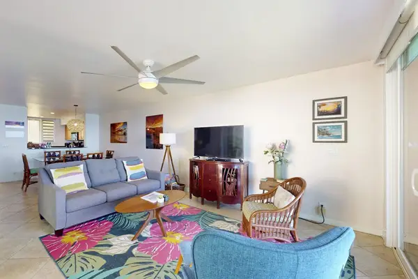 Open Living Room with Plush Sofa, Entertainment Center with Flat-Screen TV, and Ceiling Fan